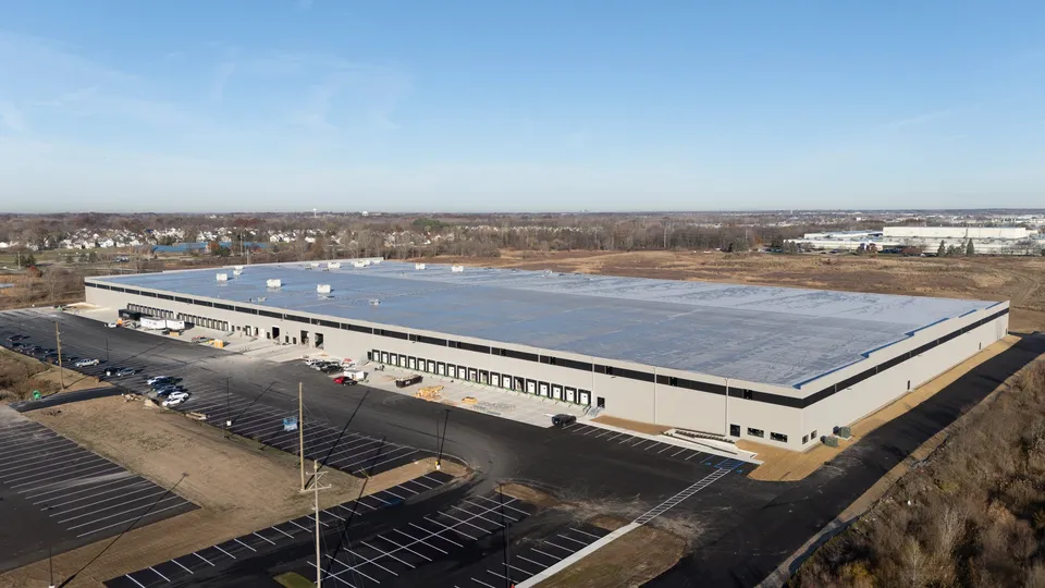 Aerial view of the 60th Street Warehouse in Kentwood, a long white industrial building with truck courts and parking