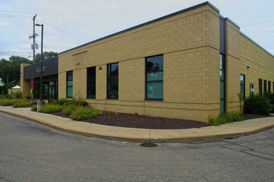 Rear corner of 833 Michigan Street NE with parking area