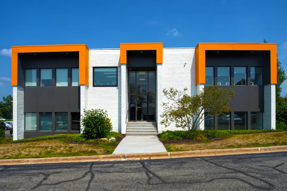 Front entrance of 4500 Cascade Road SE, two-story office building with orange accents